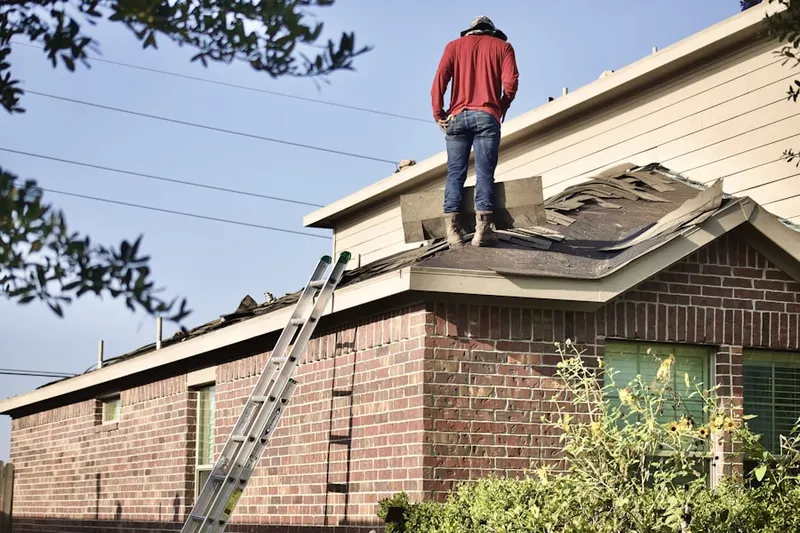 Professional roofer working on a residential roof in Balboa Island